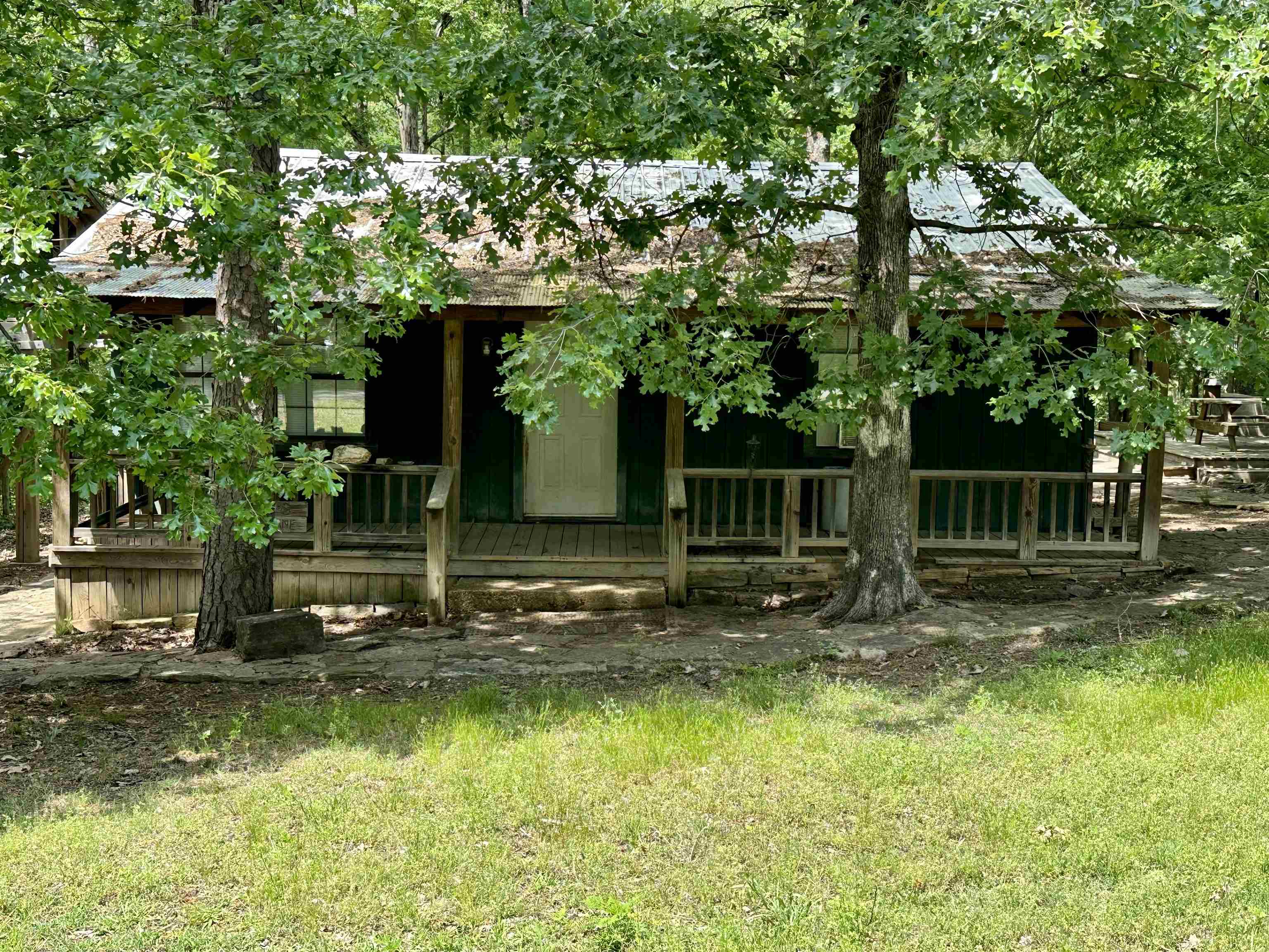 Perfect weekend Greers Ferry Lake retreat. Access the lake from your own back yard or just a short walk to the boat launch. Updates in 2021 - Metal Roof installed, 3 window AC units, water heater replaced, replumbed, floors leveled. All furniture, appliances & TV's will convey with the cabin. Seller has only a few personal items to remove. Large enclosed back porch, multiple decks & firepit area for outdoor entertaining. Frame work for large carport to store your boat, all it needs is a roof.
