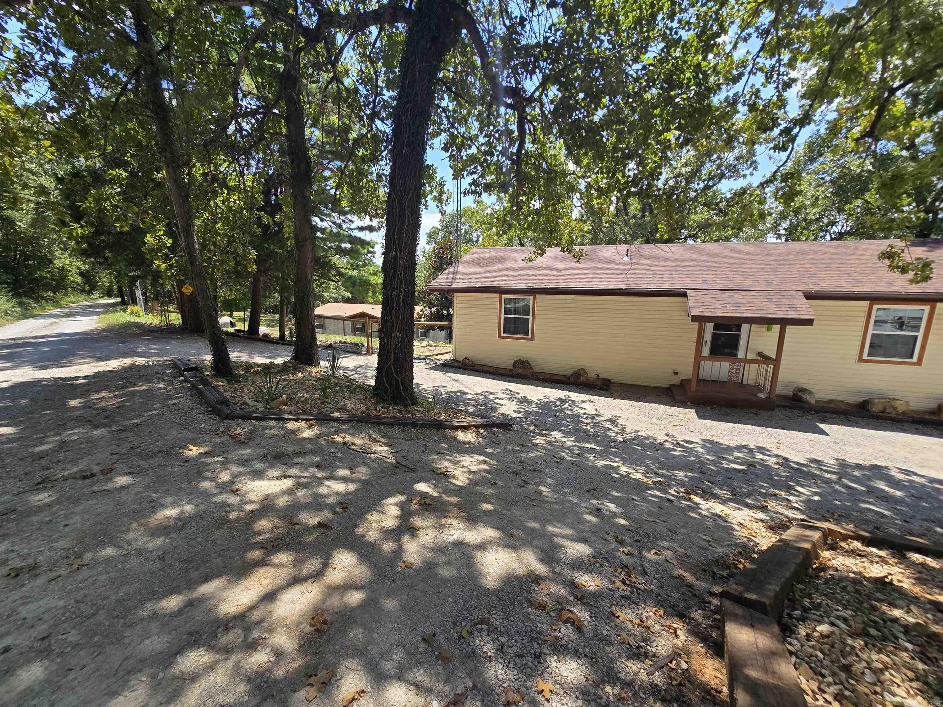 Two homes on nearly 7 acres! The charming main home features 3 bedrooms, 2 bathrooms, a partial basement, and a workshop—plus a screened-in porch overlooking the spacious backyard. The guest home is a 4-bed, 2-bath manufactured home on a permanent foundation, perfect for extended family, rental income, or extra space. Enjoy peaceful country living with modern updates, including a brand-new well and a roof that's less than a year old. The 6.98-acre property offers privacy, open space, and endless potential for gardening, hobbies, or outdoor fun. Located near Lake Norfork and Pigeon Creek for boating, fishing, and recreation. This is an ideal setup for multi-generational living or investment opportunities. Don't miss this rare find—two homes, acreage, and natural beauty for just $449,999!