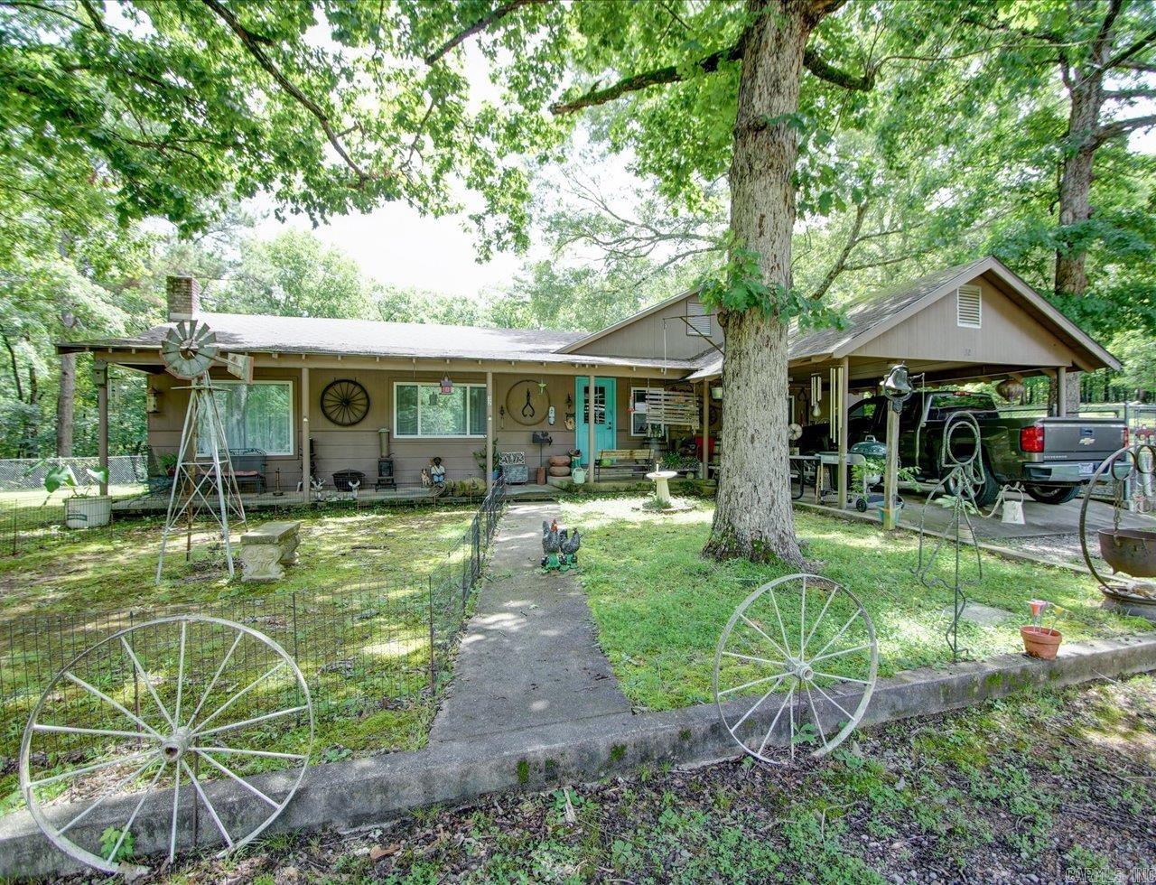 2 MINUTES TO THE OUACHITA RIVER! Charming rustic country home nestled on 1.7 wooded acres, offering peace, privacy, and potential. Located just minutes from Ada and Denby Trailheads, this serene retreat is surrounded by trees and nature. Enjoy your morning coffee on the large covered front porch or cozy up by the pellet stove on chilly evenings. Inside you'll find a spacious kitchen with ample storage and prep space, neutral paint throughout, and a no-step, walk-in shower for easy access. Step out the back door to your own private pond and fishing dockāperfect for quiet afternoons outdoors. The property also includes a huge shop with a woodburning stove and half bathāideal for a workshop, guest suite conversion, or rental potential. Plus, a large shed and fenced yard for pets or hobby use. With its proximity to the river, generous space, and multiple outbuildings, this property is perfect as a vacation getaway, short-term rental, or full-time homestead. COME AND SEE! Agents - Please schedule all showings through Showing service.