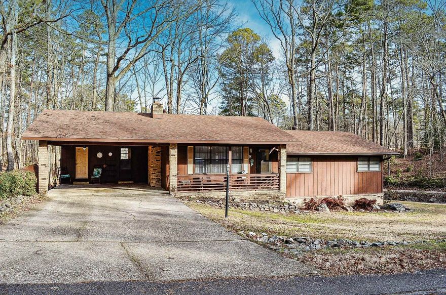 Welcome to your dream retreat!  This 3 bedroom, 2 bath golf front home offers a serene park-like setting perfect for relaxation and outdoor enjoyment.  The spacious living and dining area features a gas-log fireplace, creating a warm and inviting atmosphere.  Enjoy your view of the Desoto Golf Course fairway from the expansive den, featuring abundant windows that fill the space with natural light.  Lots of storage spaces here!  The finished crawl space is heated/cooled and includes a cozy man-cave with two divided work spaces and a half-bath, great for the hobbyist.  Located in prestigious Hot Springs Village, the largest private gated community in the U.S.  Enjoy 11 pristine lakes and 9 championship golf courses (one being an executive course).  Situated in the foothills of the Ouachita Mountain Range, this home would also make a great vacation rental in an area of abundanct of nature trails. Oh, and Pickleball close by!  Convenient to shopping, pharmacy and medical facilities less than 1/2 mile away.  Zero turn lawn mower can stay with acceptable offer.  ** Please note property is selling "As Is" condition and has a $2000 new member fee charged to Buyer at closing. **