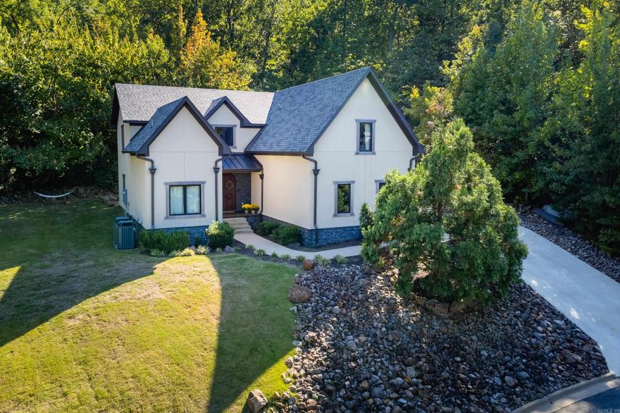 One-of-a-kind home in Chenal Valley privately tucked away at the foot of Shinnal Mountain. This is a one-owner home priced below recent appraisal! Upon entering, you're welcomed into an open concept design featuring a two-story vaulted ceiling and fireplace in the great room, exposed ductwork, and custom carpentry/cabinetry throughout. The gourmet kitchen boasts a large island w/ breakfast bar, large corner pantry and high-end SS appliances including a 6-burner gas range, built-in espresso maker, and microwave drawer. Home offers 4 spacious bedrooms—2 on each level—and 3 full baths. The two downstairs bedrooms share a full bath w/walk-in shower. Upstairs, the vaulted primary suite showcases a huge en-suite bath with oversized vanity & walk-in shower w/ multiple shower heads, along with a second bedroom w/ large loft area, second full bath and a generous bonus room. The designated green space behind and undeveloped lots on either side create a peaceful, natural retreat setting to enjoy from the covered back patio or the level side yard. Large laundry/mudroom off garage. Two-car garage and extended driveway/parking pad.