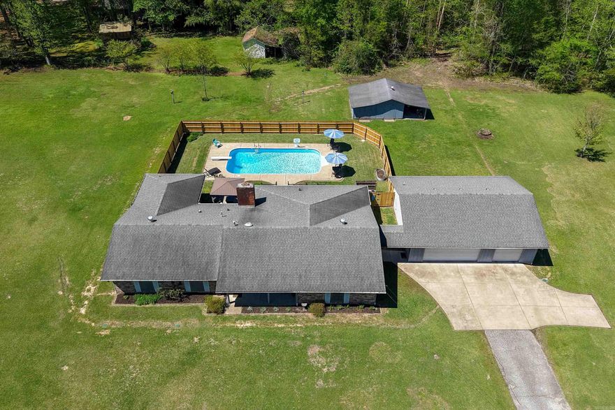Welcome to this beautiful open-concept home on over one acre in Arkadelphia! This 3 bedroom 2 bath home is perfect for entertaining or just spreading out.  It includes a spacious living/kitchen area along with an office and a large bonus room that connects to the living area through french doors. Enjoy summer days by the pool and beautiful sunsets on the west facing back porch. Take advantage of the 3-car detached garage with extra depth plus a separate 20x32 storage building—perfect for hobbies, storage, or extra workspace. Plenty of room to spread out and make it your own!