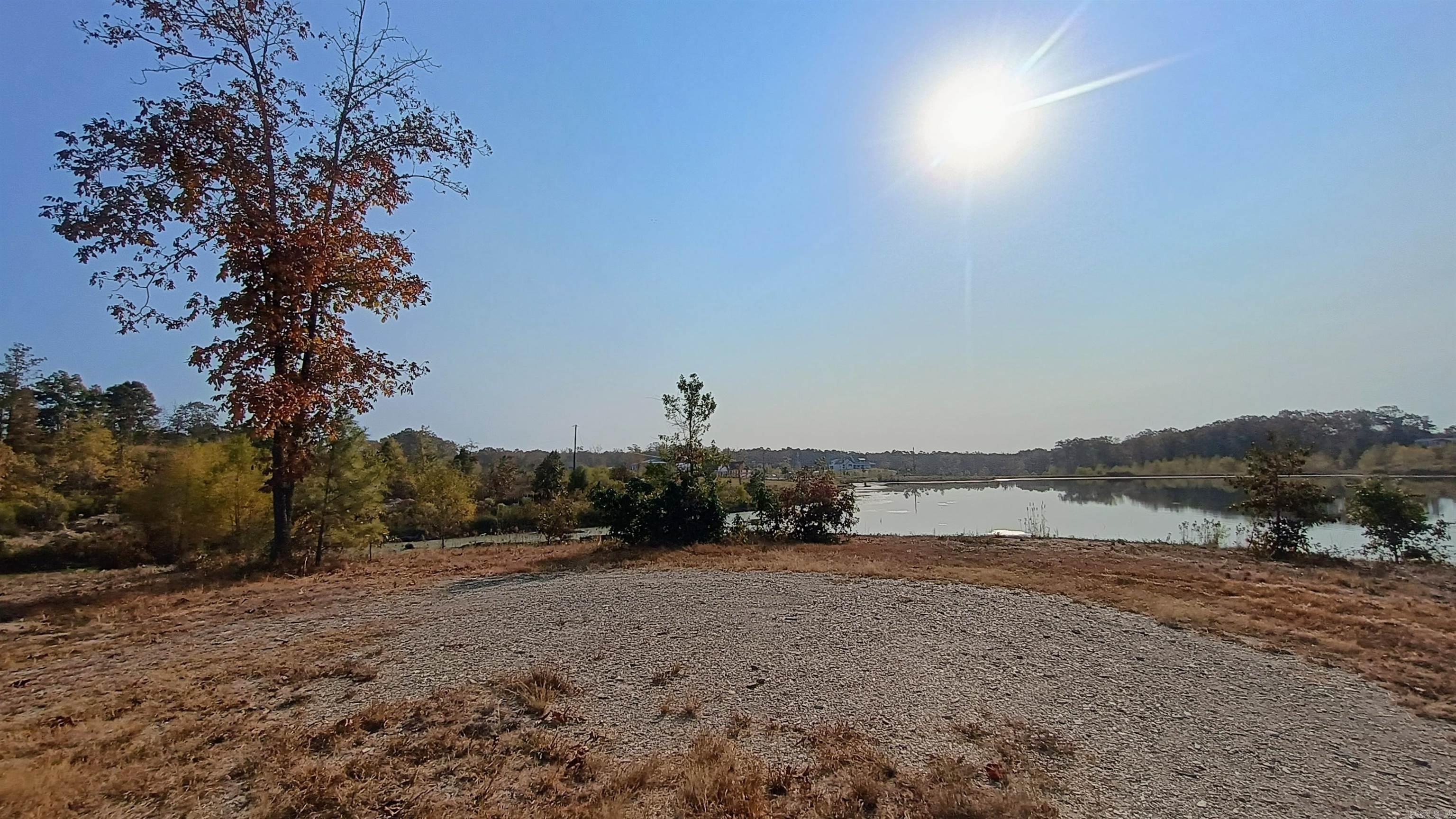 Embrace the charm of lakeside living in this hidden gem of a community, where tranquility meets exclusivity. Discover the allure of this lakefront lot nestled on the shores of a small, pristine lake, offering a rare opportunity to create your own private oasis. Situated in a quaint gated community, this property provides an intimate and peaceful setting, perfect for those who appreciate a close-knit community and the beauty of a smaller lake. Imagine waking up to the gentle rustle of leaves and the soft sounds of the lake, creating a sense of serenity that only a small, private community can offer. With direct access to the tranquil waters, you can enjoy leisurely strolls along the shoreline, paddleboarding, or simply relishing quiet moments surrounded by nature. The small size of the community ensures a tight-knit atmosphere, fostering a sense of camaraderie among neighbors. This lakefront lot is not just a piece of land; it's an invitation to create your personal haven, where you can escape the hustle and bustle of everyday life. Minimum 1350 sqft.