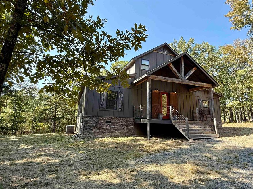 Perfectly positioned along the 2nd hole of Tannenbaum Golf course, this $1,950 sq. ft. home offers the ideal blend of rustic charm and comfort. The main level feature 3 bedrooms and 2 full baths, complemented by beautiful barn wood flooring and tall ceilings adorned with stained tongue - and- groove wood. The kitchen is designed with a large wooden island, granite countertops, and a custom backsplash- perfect for gathering with family and friends. A rock gas fireplace creates a warm and inviting atmosphere on cool winter evenings, while expansive windows flood the home with natural light and frame the beauty of the outdoors. Upstairs, you'll find a additional bathroom and generous bonus space ideal for entertainment, media rm, or guest accommodations. Step outside to the covered back deck and unwind after a round of golf or a day on the lake. Outdoor ceiling provide comfort during Arkansas summers, and nearby pond along the 2nd hole offers a peaceful spot for fishing and making memories with the kids.  Furnishing are negotiable (with a few personal exceptions), offering the opportunity to make this welcoming home your own with ease.