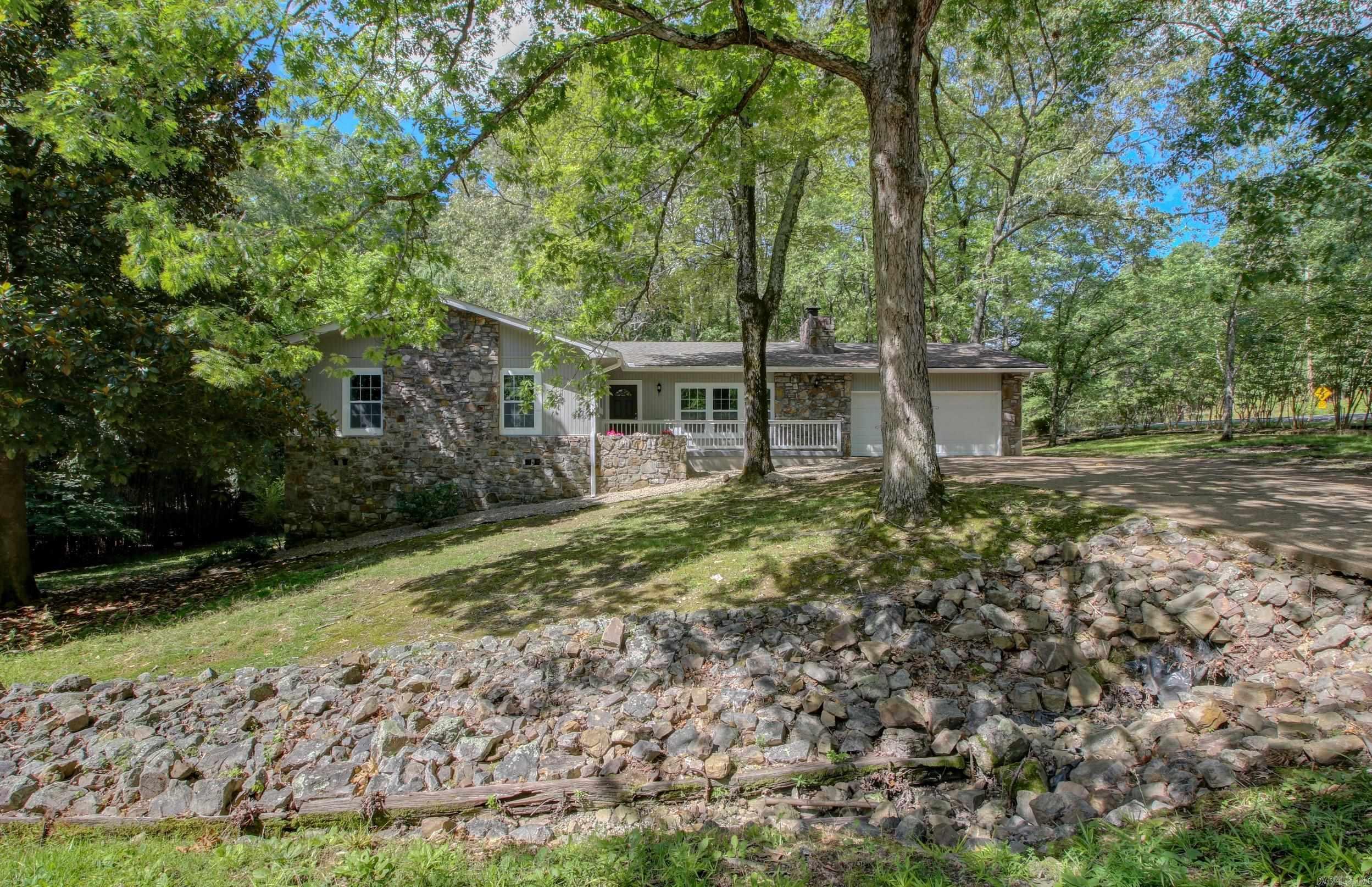 Wow! You have to come see this beautifully updated 4 bed 3 bath home on the West side of Hot Springs Village. Brand new HVAC, Flooring throughout, Granite Counters throughout, custom cabinets and closet shelving, finished basement, interior and exterior paint, and Garage door opener. Enjoy the wooded green space out on the back patio or from the comfort of the climate controlled sitting room. Three rooms on main level including master en suite. One room with en suite whole bathroom and living area in the basement with WALK-OUT access in back WITH PARKING! Could be great rental income. 2 minutes from the West Gate and 20 minutes to Bath House Row. MAKE US AN OFFER!! Happy to negotiate!