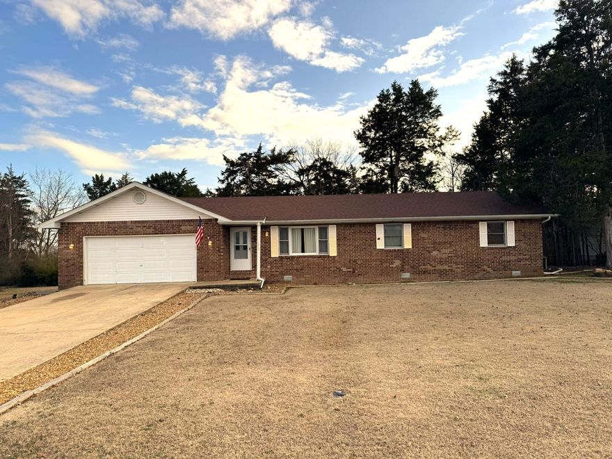 This Gorgeous All-Brick three-bedroom, two-bath beauty is conveniently located near schools and shopping. Enjoy a large living room, and a well-equipped kitchen featuring, a Jenn-Air gas countertop stove. A spacious dining room that leads out to a covered deck. Plenty of storage space, plus a walk-in closet in the Primary Bedroom. A roomy laundry area, and a two-car garage. Outside, relax in the fenced backyard with a comfortable covered deck, plus an RV carport an available  RV electrical hook up and water hook up. Don’t miss your chance—schedule a viewing today!