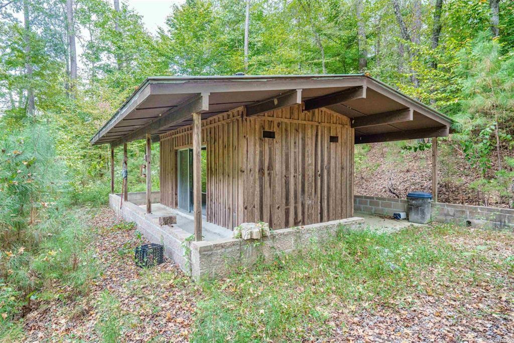 13 wooded acres, with a rustic cabin, surrounded by nature!