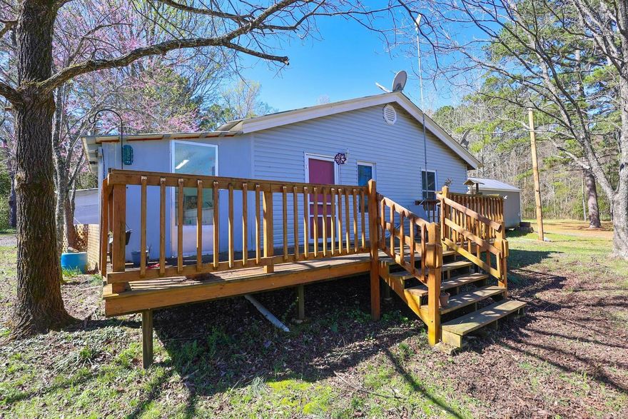 If you're looking for a property close to outdoor adventure, this one is worth a look. Located just 7 miles from Wolf Pen Gap, 6 miles from Albert Pike Recreation Area and Little Missouri Falls, and about 20 miles from Mena, this 3-bedroom, 1-bath home sits on 2.29+/- acres in a great location for enjoying the Ouachita Mountains.  Built in 1952, the home offers approximately 1,148 square feet and includes a full basement for storage, additional living, or workspace. Outside you'll find a 28x36 garage, mature pecan and walnut trees, and areas already set up for small animals, including a chicken coop. Three exterior water spigots provide convenient access for watering animals, plants, and landscaping.  An outdoor kitchen area adds extra space for cooking and entertaining. A new 45-gallon water heater has also been recently installed.