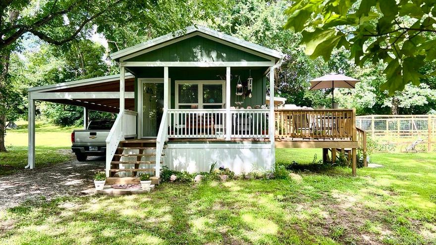 AMAZING CREEK! Beautiful Year-Round Creek & Home to create the perfect homestead! Motivated Sellers! 2024 Home is Move-In Ready! 2 Bedroom, 2 Bath - New Vision 16' x 66' mobile home with Smart board siding.  There are not enough words to describe the serenity of this location. The home borders alongside the creek, you can listen as the water flows or better yet take your lawn chair and set in the creek! Home features an open floor plan with VLF throughout. Easy access to everything in the home & walk-in shower in the master bath. Decks for enjoying the outdoors, a 60 Ft. carport & storage container for extra tools & toys.  30' x 30' garden high fenced. Home is set on 9 concrete runners with standard block framing plus along the outside perimeter. RV hookup, UV light water system. Fiber optic is available, Private well & septic. Public water is also available. All appliances convey. Fireplace does not convey. Creek has never come up in the yard and property is not in a flood zone.