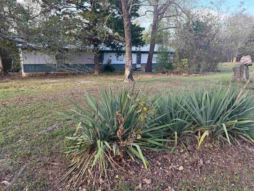 Located directly across from the Dollar General in Henderson!! Close to the lake and marina. Large circle driveway. Nestled against the woods where wildlife is seen daily! 2 bedroom 2 bath older mobile home…has had some updates. Will come fully furnished.A small unfinished house also sets on the property. New survey will be done to reflect approximately one acre to convey with the sale.