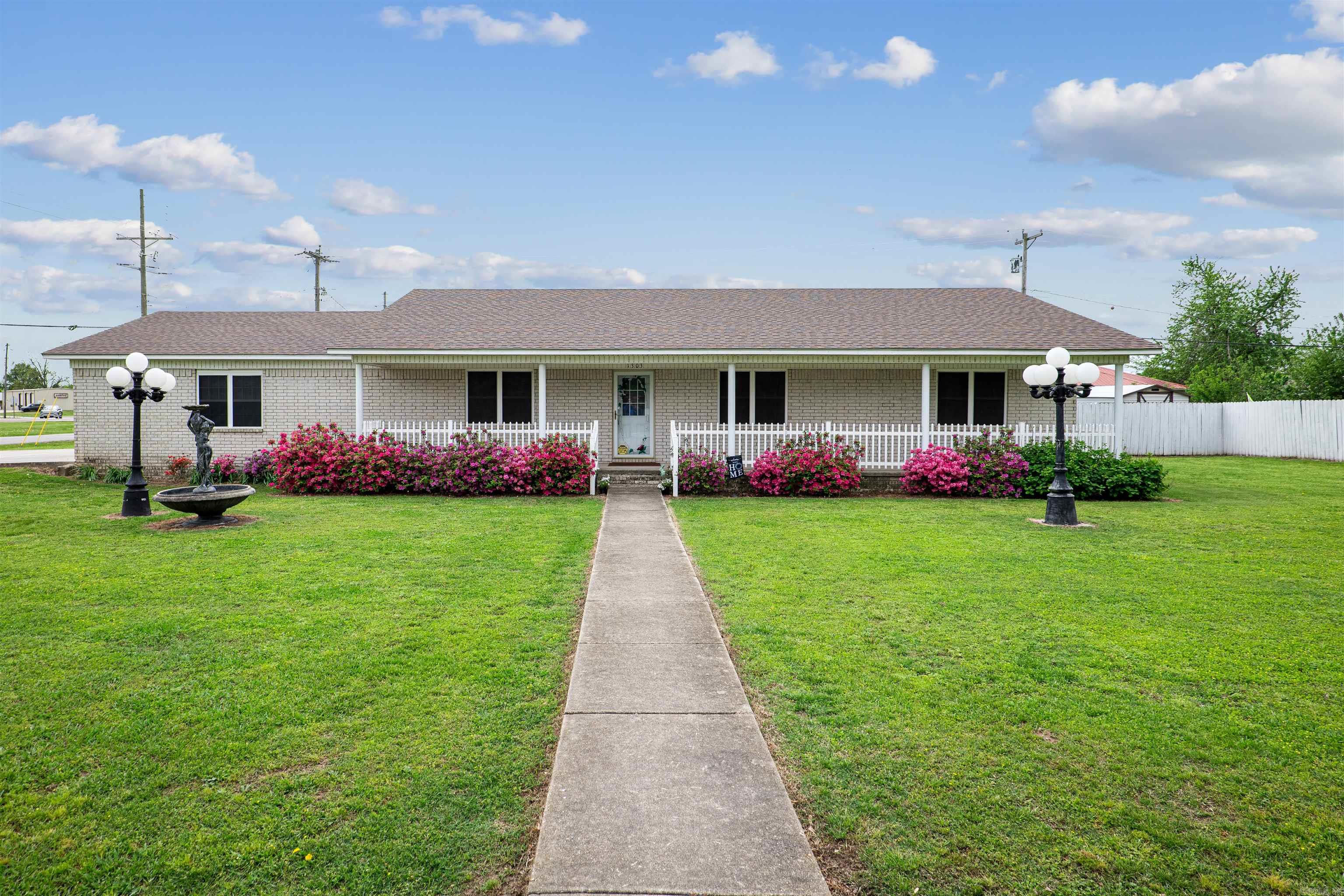Welcome to 1303 Magnolia Avenue in Walnut Ridge! This charming 1,757 sq. ft. home sits on two city lots, offering space, privacy, and a desirable corner location. Ideally situated near the hospital, dentist, clinics, pharmacy, salon, and stores, it provides everyday convenience. Inside, a bright, inviting atmosphere is enhanced by neutral tones throughout. The kitchen boasts oak cabinets and ample space for meal prep and family gatherings, while the generous living room offers a comfortable place to relax. Three spacious bedrooms provide room to unwind, and the screened-in back porch, overlooking a fully privacy-fenced backyard, is perfect for year-round enjoyment. The covered front porch invites quiet moments on a swing or rocking chairs. Additional highlights include a two-car attached garage, a laundry room, and a backyard grill for outdoor cooking. Blending comfort, convenience, and peaceful living, this home is ready to welcome its next ownerāschedule your tour today!