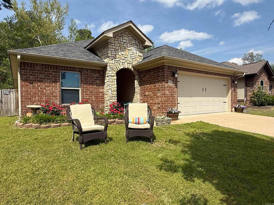 **More pics coming this evening** Check out this charming cozy home in a quiet neighborhood and conveniently located between Bryant and Bauxite! You'll love coming home to this corner lot surrounded by woods. The open floor plan feels larger than the listed square footage and the electric fireplace adds an additional heat source while the view maks the room feel cozy! Enjoy the patio in the back yard with space large enough for friends to sit around a fire pit! The privacy fence and the smart doggie door make this home ready for your fur baby. Security equipment convey! Upgrades include: Fresh new paint!  Sprinkler system for the front flowerbed a beautiful master frameless shower and dual shower heads new roof in 2023, inside portion of the HVAC new in 2017 Smart home system with complete remote access on your phone! Keyless entry to any door!