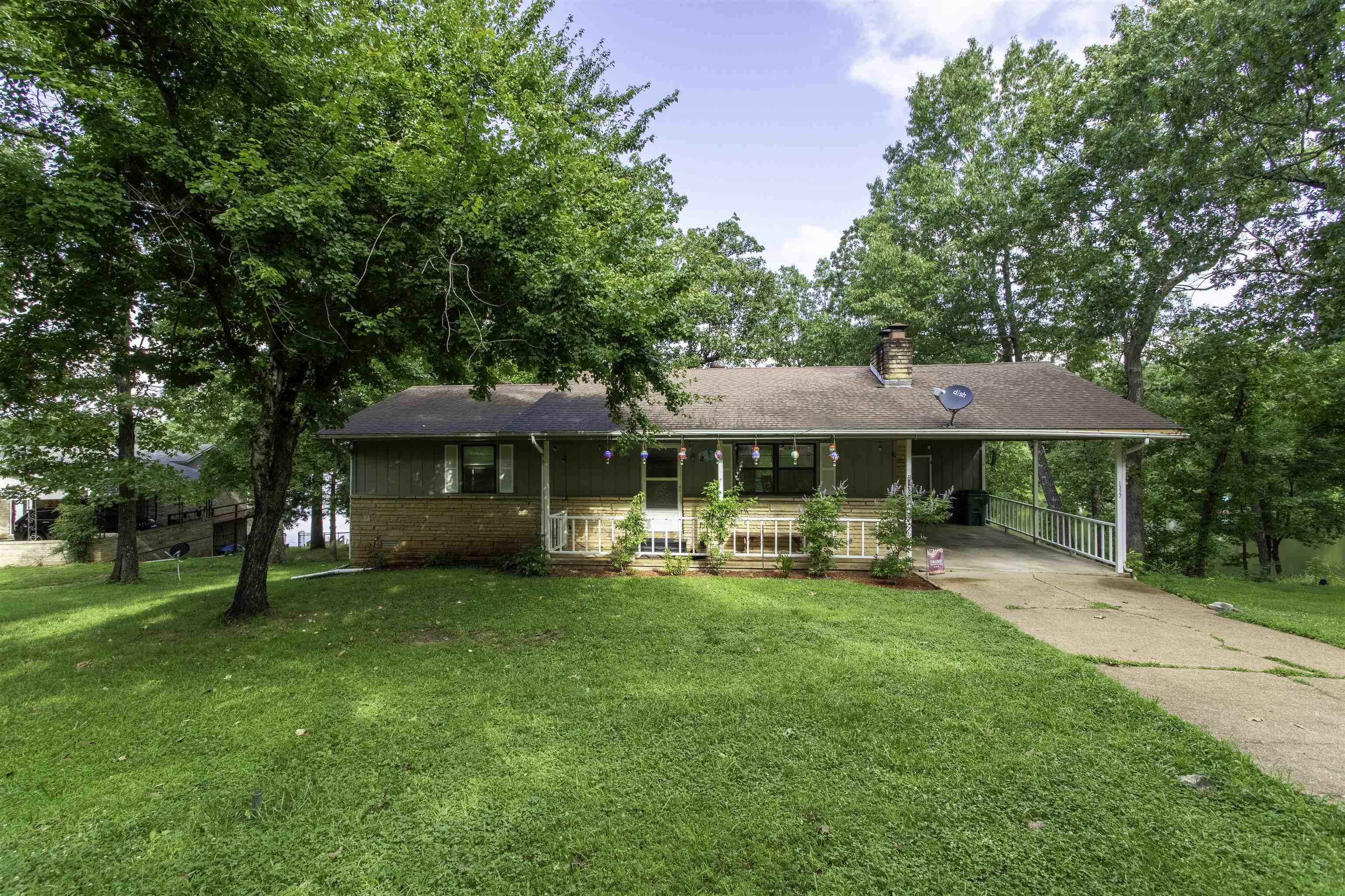 Lakefront retreat on Pioneer Lake in Horseshoe Bend, AR! Discover Lakeside living at its finest in this peaceful neighborhood tucked away in the Ozark foothills in Izard county. Close to amenities but away from the hustle and bustle of metropolitan life. This recently renovated home offers 162 ft of shoreline with concrete steps for easy lake access. Enjoy kayaking, canoeing, swimming, or fishing on this no-wake lake. The main level features 1,144 sq ft, 2 bedrooms, 2 baths, a cozy sunroom with stunning lake views, ideal for year-round enjoyment, and a cozy wood-burning fireplace. The lower level 563 sq ft, includes a spacious bonus room used as extra living space and workout area, a recently added 3-person sauna, another full bath, and a second fireplace. Plenty of storage throughout. New septic system installed in 2020. Water heater replaced recently. Peaceful setting perfect for full-time living, weekend getaways, or vacation rental potential. This one won't last long contact your favorite real estate professional to set up an in person tour.