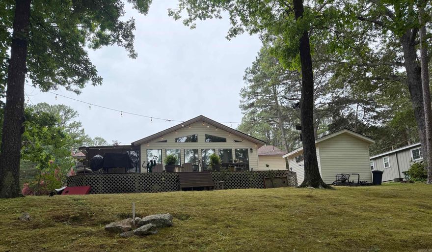 LAKETIME IS HERE! Own your home at beautiful Greers Ferry Lake!  This charming 3-bedroom, 2-bath home offers the perfect blend of relaxation, recreation, and convenience, less than 5 minutes from the Fairfield Bay Marina and located just 15 minutes from Walmart. Nestled in a small, quiet subdivision overlooking scenic Lynn Creek/Snake Cove, this property is ideal for full-time living, a weekend retreat, or vacation rental potential.  Enjoy outdoor living at its finest with a massive 41x14 deck, covered screened-in porch, flat lot, wired storage building and beautifully manicured landscaping — all designed to take advantage of the peaceful lakefront setting. Inside, you’ll find fresh paint, new LVP flooring, updated kitchen backsplash, and energy-efficient mini-split systems in every room for personalized comfort year-round.  As part of the Fairfield Bay community, you’ll also enjoy incredible amenities including ATV trails, bowling, restaurants, pools, and endless lake activities.  If you’ve been searching for an affordable lakefront escape with updates already done, this is one you don’t want to miss! Owner/Agent