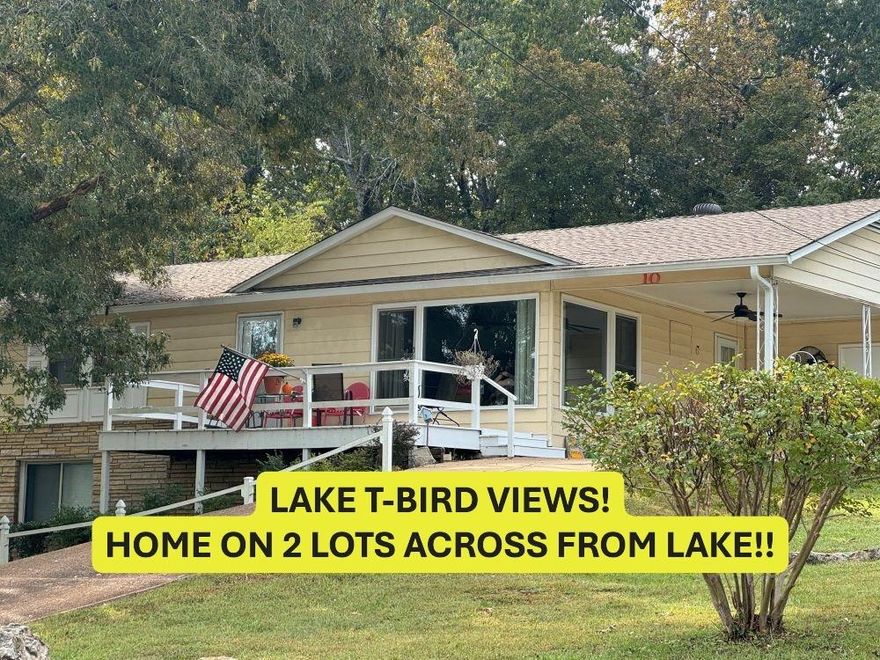 ACROSS FROM LAKE THUNDERBIRD! 2 LOTS- Over 2000 sq ft- includes Mother-in-law suite.  Upstairs vintage hardwood flooring-great character! Eat-in kitchen lots of cabinets and storage.  Huge living room looks out to T-Bird views thru big windows (views best fall-winter). 2 roomy bedrooms on main level-share full hall bath-laundry on main level. Large bonus room views nice patio with native stone walls.  Numerous uses for bonus room - has native stone wood burning fireplace (currently has electric logs) and large storage closet- with easy access to backyard. Newer storage bldg in back.  Lots of vinyl replacement windows, low maintenance steel siding. Downstairs has family room along with bedroom, 3/4 bath & lots of additional storage.  Newer h/a (Elec w/propane back-up), roof, gutters, water heater-see disclosure for ages. Washer/dryer conveys at closing, new concrete septic 2012. Lot next door - great spot for garage or shop. Home is occupied requires appointment. #2417