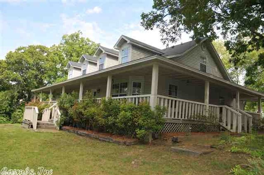 Spacious country style home on 3 beautiful acres in the Heart of West Searcy!!   Open porches on two sides of the house.Wired Gazebo.  Kitchen has been TOTALLY redone with new upgraded appliances, granite and a HUGE soapstone bar. Engineered laminate hardwood floors, HUGE utility room with pantry, and a separate mudroom.  Sunroom off master BR could be an office. 2BR/2BA downstairs, and 2 LARGE BR/1BA upstairs.  Detached garage has covered walk. AGT remarks for much  more info.