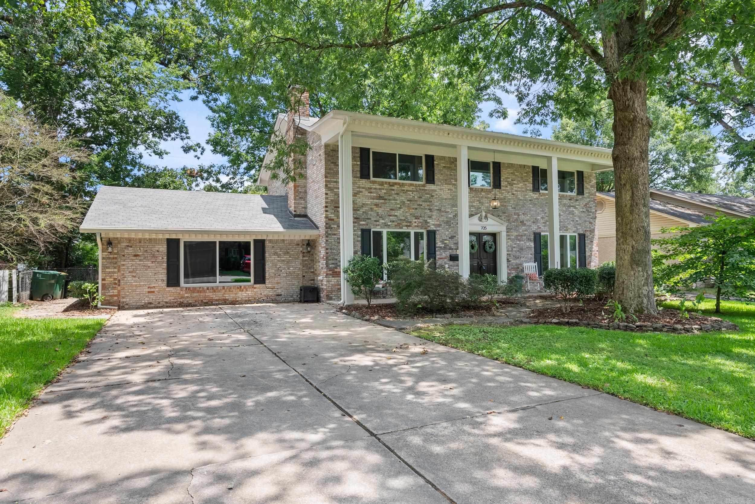 This beautiful Midtown home is conveniently located close to hospitals, downtown, shopping and restaurants. It sits on a quiet, tree-lined street and immediately welcomes you with a large, column lined, two-story front porch. Once inside, you will not be able to take your eyes off the beautiful, custom-built, wooden, spiral staircase that is the centerpiece of the foyer. The foyer is flanked by a den on one side & a living room on the other. The recently updated kitchen includes updated cabinets, backsplash, quartz counters, stainless refrigerator, stainless gas range & microwave. Downstairs you will also find a huge bonus room (with cedar storage room), formal dining room, laundry room & updated 1/2 bath. The primary bathroom has also been completely updated! Other recent updates include window replacement throughout, luxury vinyl flooring downstairs, new carpet upstairs, & much more (see update list). Off the kitchen is a covered patio that overlooks the large, flat, & fully fenced backyard. The backyard also includes a nice sized brick storage building. This home is a great space buy for the area and with all the thiings it has to offer is a must see!