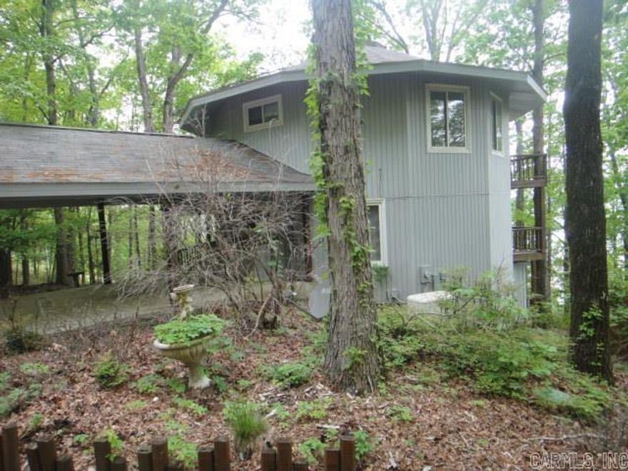 Stellar view of beautiful Greers Ferry Lake!! Contemporary house sits on 1.66 acres with views of lake on all three deck levels. 3 story with lower level being a walk-out basement. Small storage area attached to lower level. Can be 4 BRs or 3 BRs and Game Rm. Master BR is on 2nd level with almost panaramic view. Please see Agent Remarks.