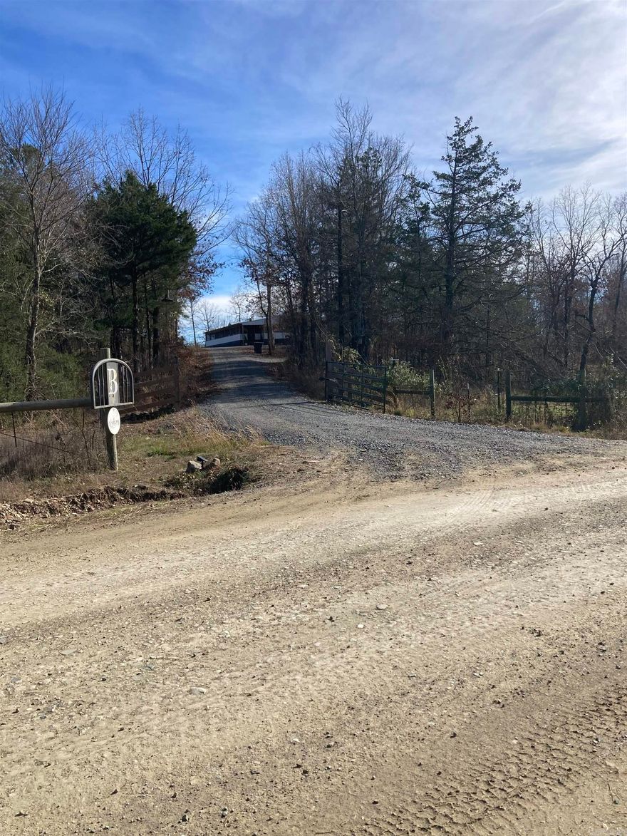 If you are looking for the one...this is it. 103+/- acre tract located in Polk County Arkansas this tract has it all. Besides over a quarter mile of river frontage on the Mountain Fork River, the 2040 sqft mobile home that sits on a 6" slab of concrete from end to end that has 3 bedrooms, 2 bathrooms, big pantry, mud/laundry room and all the necessary essentials, it has open functional space that is perfect for entertaining family and friends. The fireplace inside is perfect for that relax time after being outdoors all day this time of year and to help with that heat bill. With every great interior, it would only be right to have a 2060 sqft wrap around screened in porch/deck with outdoor ceiling fans in place and lighting along with a ramp and steps in place for easy accessing. A Beautiful 40X60 Shop/Garage/Barn sits just off to the side with power bay doors. Stock pond on the property and an abundance of wildlife for the avid hunter. With the river frontage on the mountain fork river you can enjoy the floating and fishing during the warmer months on your own piece of property. Over 4 miles of trails its perfect for the side by side.