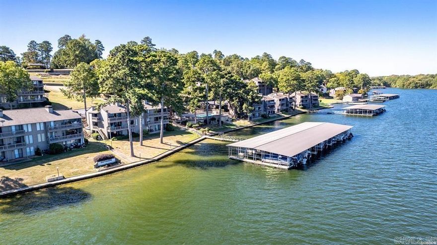 Welcome to your dream lakefront retreat! This stunning 3-bedroom, 3-bathroom fully furnished condo offers the perfect blend of comfort, luxury, and outdoor enjoyment. Located in a stunning lakeside location, you'll experience breathtaking views and year-round water access with your own covered boat slip.  Inside, you'll find spacious living areas designed for relaxation and entertainment. A wet bar and game room make hosting guests a breeze, while the open-concept layout seamlessly connects the modern kitchen, dining, and living spaces. Each bedroom is generously sized, ensuring privacy and tranquility.  Step outside and soak in the beauty of Lake Hamilton on your two covered patios also enjoy cooking on the grilling patio. Take advantage of the community amenities, including sparkling swimming pools and tennis courts, offering endless opportunities for recreation and leisure.  Whether you're seeking a weekend escape or a full-time residence, or an investment property this exquisite condo is the perfect place to enjoy lakeside serenity with all the conveniences of this prime location, including nearby restaurants, shopping and marinas with a quick trip to Oaklawn or Downtown Bath H