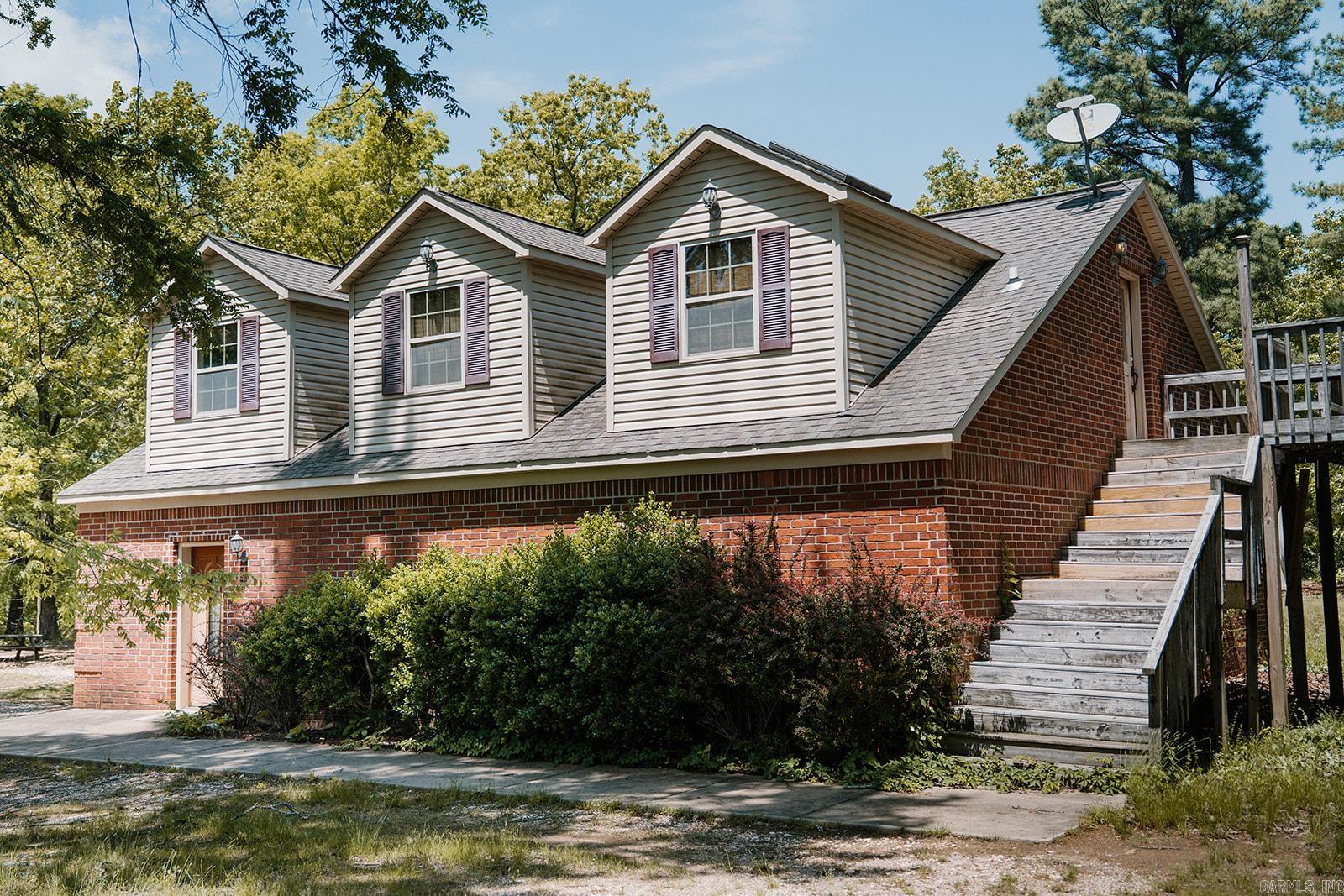 COME CHECK OUT THIS VERY UNIQUE LOFT STYLE PROPERTY NESTLED ON A LITTLE OVER 5 ACRES IN SALINE COUNTY. BOTTOM LEVEL IS A GAME ROOM WITH AN ADDITIONAL BEDROOM AND FULL BATH. A DRY BAR IS INCLUDED IN THE DOWNSTAIRS AREA AS WELL AS LAUNDRY ROOM. UPPER LEVEL INCLUDES ONE BED AND ONE BATH, KITCHEN AND SMALL LIVING AREA! ALSO LOCATED ON THE PROPERTY IS AN ADDITIONAL MOBILE HOME PAD WITH CONNECTIONS. MOBILE HOME MOVED OFF THE LAND SEVERAL YEARS AGO. CASH ONLY!!