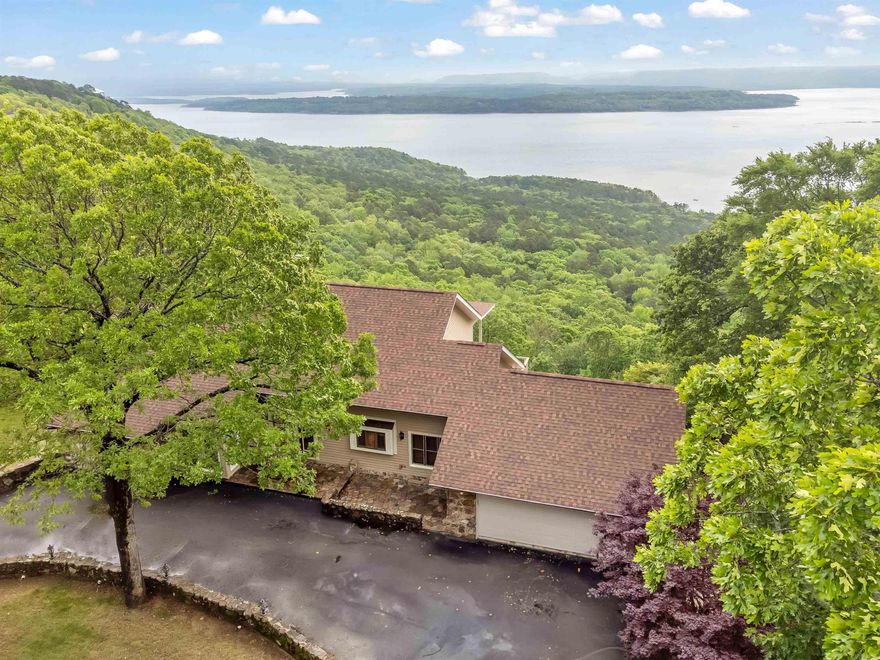 Breathtaking views of Greers Ferry Lake! Spanning over an acre, the lot features extra landscaping that blends seamlessly with the surrounding nature, creating a serene and private oasis. The home itself boasts a newly remodeled kitchen, new roof, new HVACS, panel for generator, porcelain tiled garage equipped with a sink and cabinets, in-ground Rainbird sprinklers, and views everywhere you look. Garage door and thermostat have Wi-Fi control capabilities. Mineral rights convey. Property is getting royalties. Outdoor living is elevated to new heights with two large decks offering stunning lake views, perfect for entertaining or quiet reflection. The presence of tons of wildlife adds to the allure, offering a front-row seat to nature's majesty. This property is not just a home, but a retreat from the everyday, a sanctuary where the wonders of nature meet the pinnacle of comfortable living. Be sure to check out the drone footage and 3D home tour. Make this lake view home yours today!