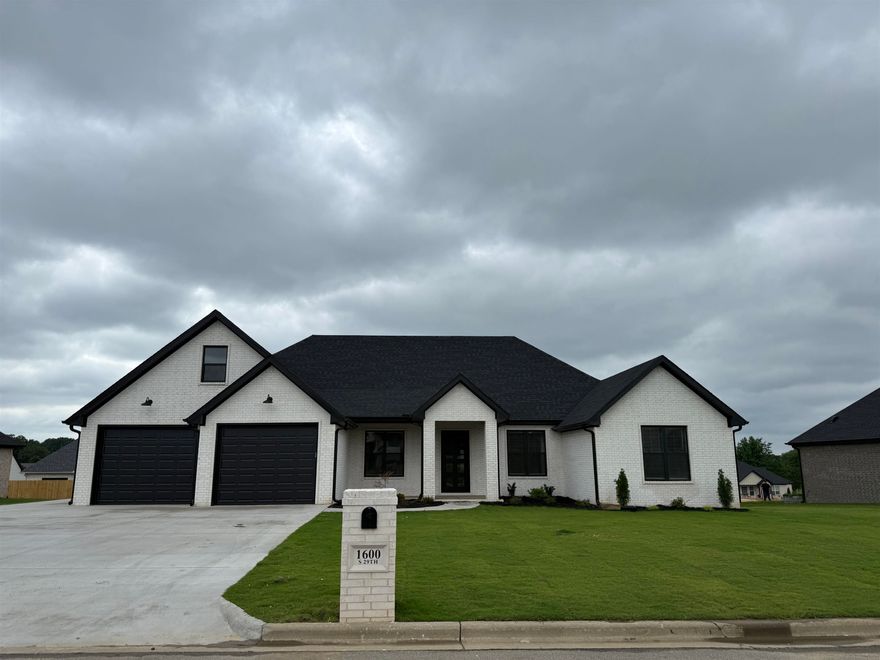 Beautiful new construction, all brick 4 bedroom modern ranch style home with gas log fireplace, two car garage and side entry golf cart garage, three full baths, pantry and laundry room, Over 2300 sf of living space with covered back patio, open concept and split bedroom plan, concrete wood like floors, grilling patio and stainless appliances.