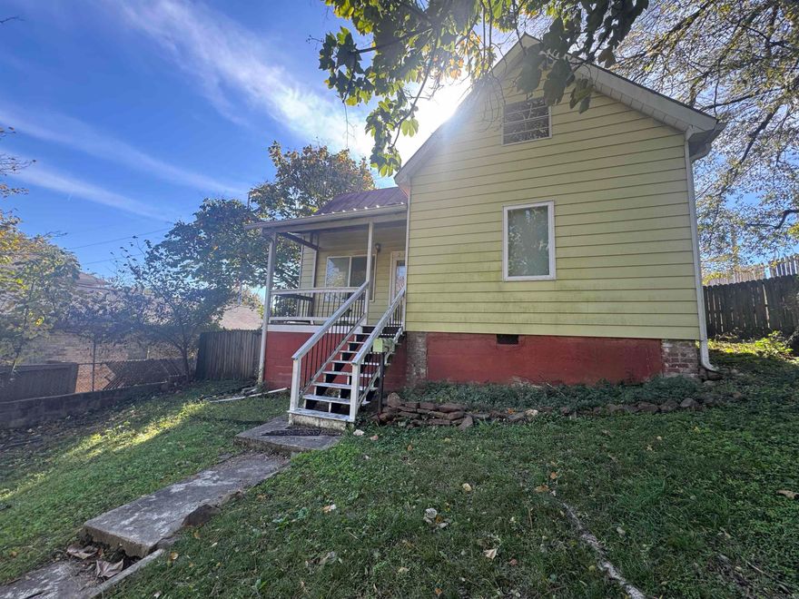 Charming historic bungalow—believed to be the original trainmaster’s home and the oldest in the neighborhood! Fully rewired from knob-and-tube to grounded Romex with breakers. Features tall ceilings, bamboo flooring, spacious living room, tankless water heater, and Jacuzzi tub. Unfinished attic with new joists and subfloor offers room to expand. Sits high above the street with mature trees for privacy. Back alley access, new privacy fence, and storage building that conveys. Adjacent lot used as a garden. Sold as-is. Seller will not make repairs Recent inspection report available. Agents see remarks.