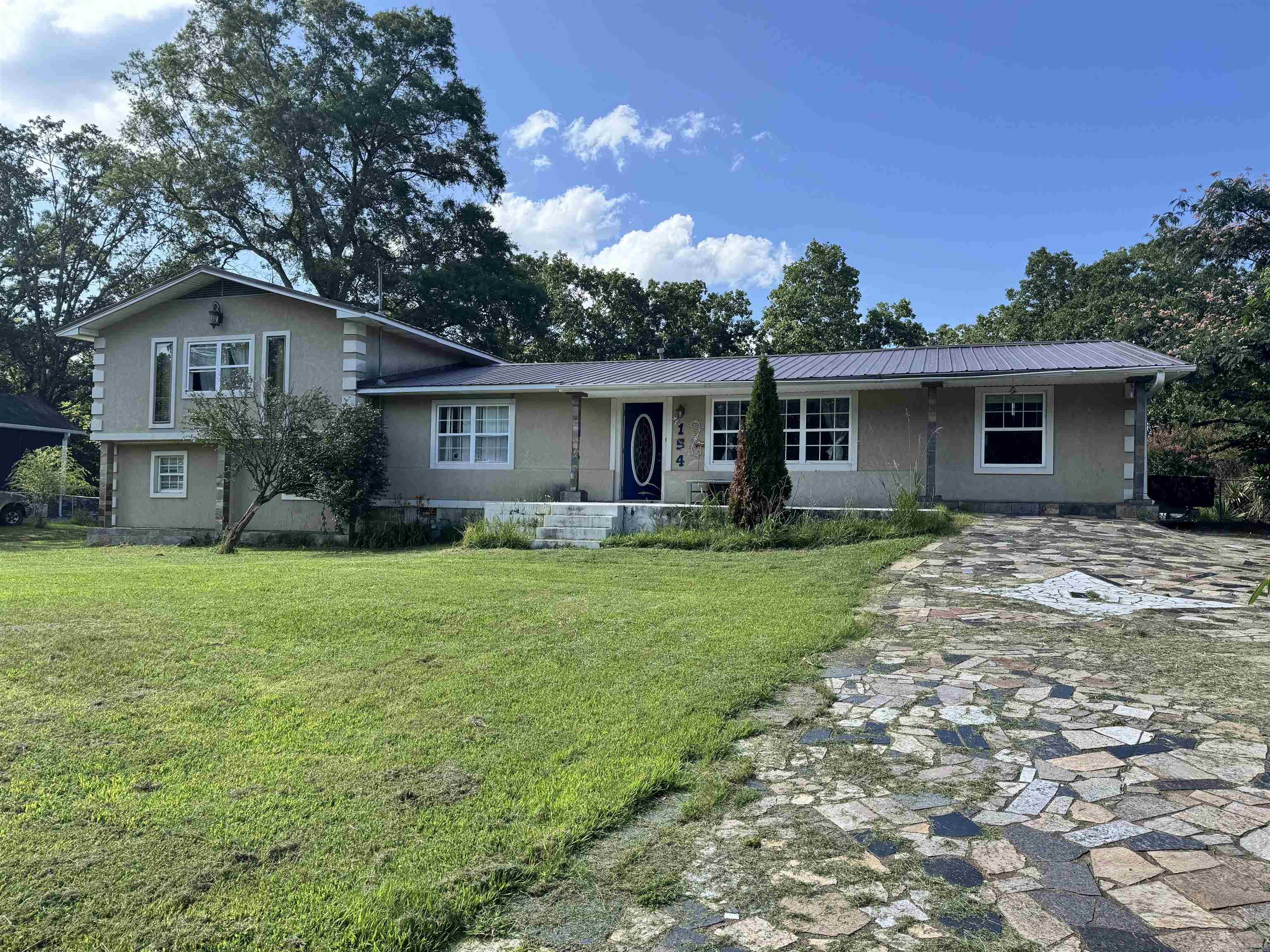 This home has it all! This 5 bed, 2.5 bath, 2800 square foot home is located in Lake Hamilton School District and just minutes to Hot Springs. Main level of the home offers a living room, designated dining room, sizable kitchen, breakfast nook, 2 bedrooms and full bathroom. Off the dining room, the home offers a mud room, laundry area, and half bath. Upstairs would make the perfect master suite with a little ingenuity! Downstairs would be great for a game room or extra bedroom with a living space. Also, new metal roof installed in 2023. With a little love and TLC, this home would be perfect for first time homebuyers or investors looking to add to their portfolio. It's priced ready to sell, so get your private showing in now!
