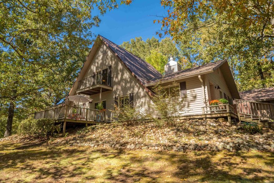Discover your dream A-frame retreat on a stunning 5-acre partially wooded lot with a serene pond! Just 2 miles from Lake Ouachita, this 4-bedroom, 3.5-bath home offers versatility as a primary residence, weekend getaway, or short-term rental. Enjoy an office, sunroom, and 2,020 sq. ft. of living space. Conveniently located on the highway for easy access, yet set back with a long driveway for ultimate privacy. Experience nature and tranquility in this perfect escape!