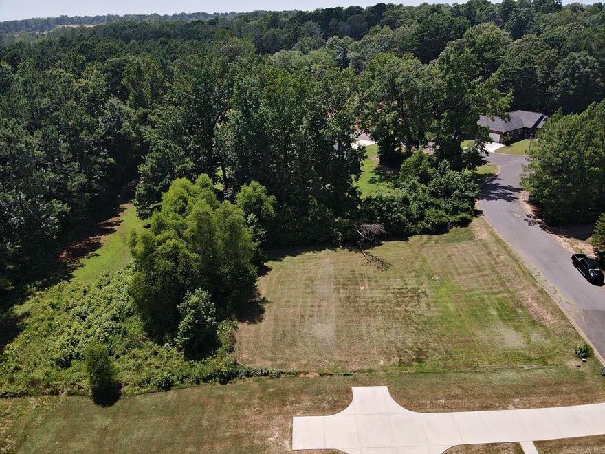 Beautiful lot in the city limits but feels like the country. Backs up to an undeveloped wooded area that gives privacy and wildlife. The site has utilities available at the street and is ready for development. Call list agent to see what potential this property has. Will share what a NEW construction "COULD" look like on this site. 870-403-2398