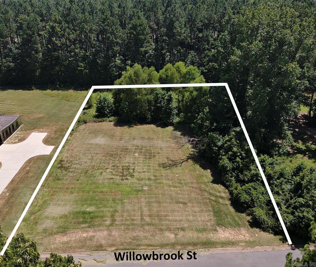 Beautiful lot in the city limits but feels like the country. Backs up to an undeveloped wooded area that gives privacy and wildlife. The site has utilities available at the street and is ready for development. Call list agent to see what potential this property has. Will share what a NEW construction "COULD" look like on this site. 870-403-2398