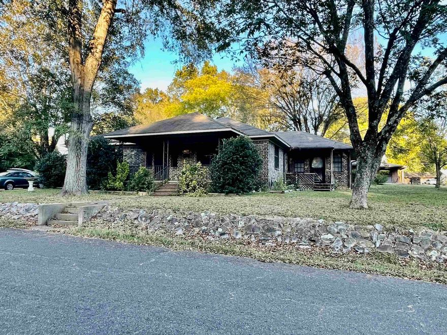 Nice home with huge yard,  1.2 acres.  Main house has 3 bedrooms, with split floor plan.  large living dining space and kitchen is a nice size.  Appliances to convey.   Large side yard could be used for a rental unit or for a large shop and fenced in yard.  The outbuilding has 3 sections.  One section can easily be used for an office space.  There is no bathroom in the outbuilding but would be a great space for a small getaway or gathering spot.  You don't find spots like this inside the city limits often.  Call today for your private showing.  There is NO Seller's Property Disclosure will be provided.