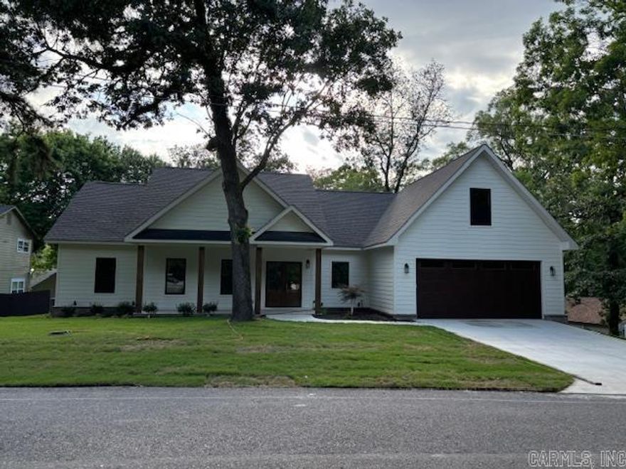 Brand new construction. This stunning 4 bedroom 2.5 bath is located in Lakeside School District. Inside, you'll find a beautiful open floorplan that welcomes your family and guests. Every detail and feature has been thoughtfully designed. Living area features a vaulted ceiling with wood detailing and an electric fireplace that adds a cozy touch. The sleek kitchen has a granite top large island, stainless steel appliances, and plenty of counter space to prepare meals. The master suite offers custom his and her closets with built ins, luxurious sized shower, his and her granite top vanities for ultimate comfort and convenience, and featuring a large soaking tub with a view of Lake Hamilton. Come see it today!