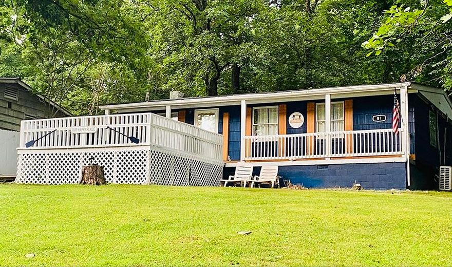 This home books well on a nightly rental program, while being available for the owners to reserve for their family and friends time. Three bedroom, 1 & 1/2 bath home with 63 feet of Lake Cherokee water frontage and private boat dock across the street.  2021 house shingles, 2022 luxury plank flooring and mini-split H/A system, 2025 water heater, new gutters front and back, and carport shingles.  Double pane vinyl windows almost throughout, backyard privacy fence, and beautiful lake view from the front deck across the lake lot. Appliances, Blink surveillance system, and wooded lot adjoining the house are all included, vacation furniture is negotiable.  A great full-time or part-time home for enjoying life and making memories!