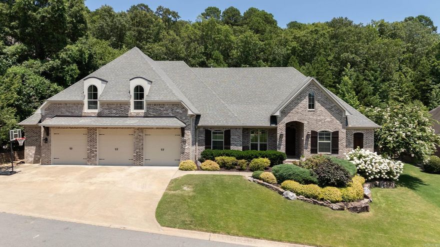 ABSOLUTELY BEAUTIFUL! YOU WILL LOVE THE FEEL OF THIS AS SOON AS YOU WALK IN THE FRONT DOOR! The stunning Great Room with vaulted ceiling really make this feel special.  Custom Built/One Owner home with 3+ car garage.  All bedrooms on the main level with Bonus Room & full bath upstairs.  The Great Room is open to the spacious kitchen with large center island, Viking Appliances, wine fridge, cozy breakfast nook with bench seating flanked by built-in shelving.  Primary suite is lovely and  spacious. You will love the spa-like bath and massive walk-in closet with hidden tornado shelter.  Guest rooms are separate of the Primary suite and are all good size and share hall bath with double vanities.  There is a wonderful office/craft space near the stairs leading to the Bonus/Game Room and full bath.  The outside is an Oasis and a wonderful spot to enjoy with its large covered patio, built-in grille with rotisserie unit, and level backyard area with flagstone patio area with a unique slide built in to the landscaping.  Property goes up the hill and into the wooded area. VERY PRIVATE!  A MUST SEE!