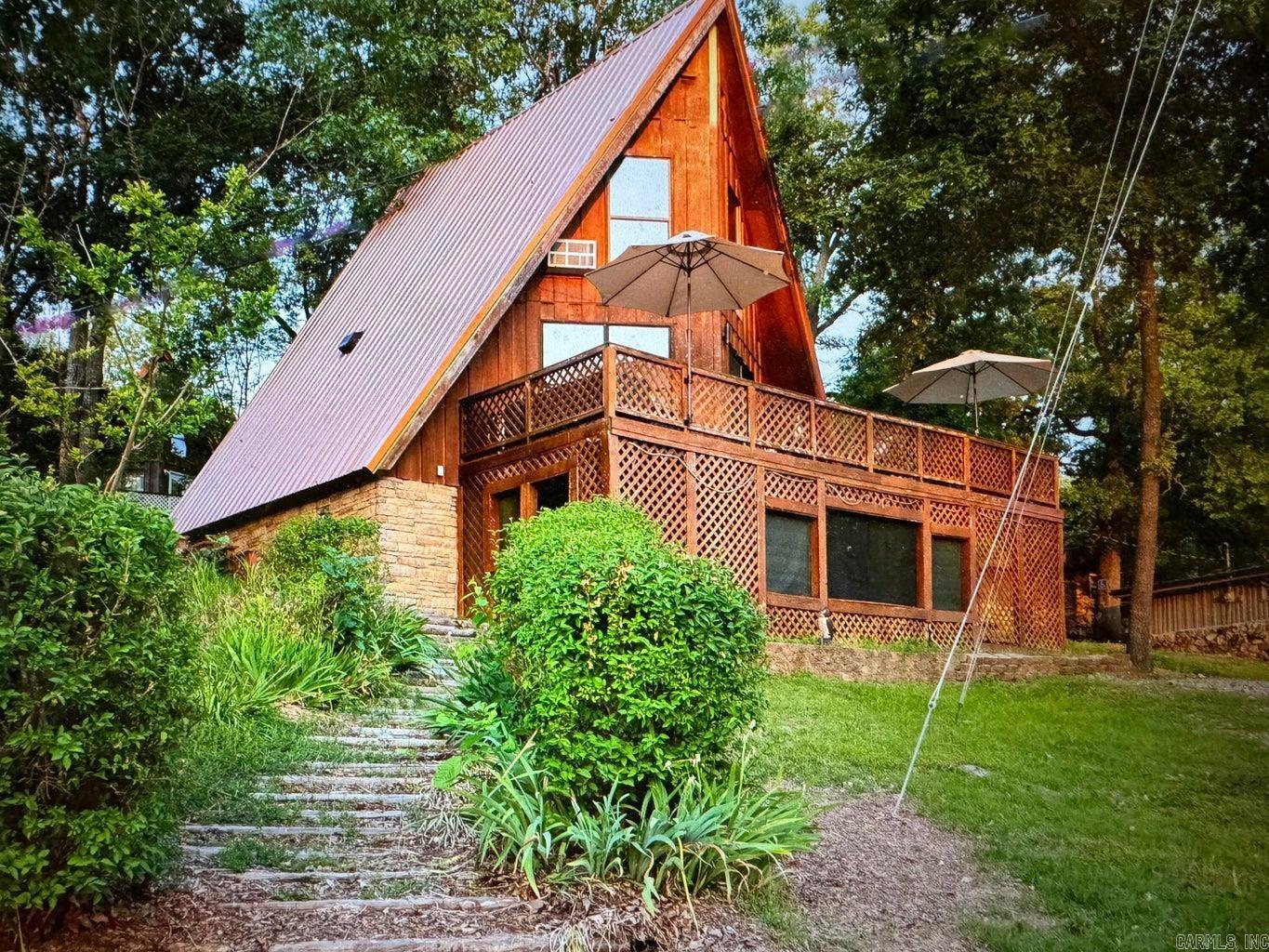 Super neat A-frame cabin with lake view. Home has a metal roof and is updated and ready to go! This one bedroom A-frame has a full and a half bath, as well as an open floor plan. Large deck with a lake view to enjoy outdoor living or just sit and watch the sunsets. Home can be purchased with the furnishings with acceptable terms.