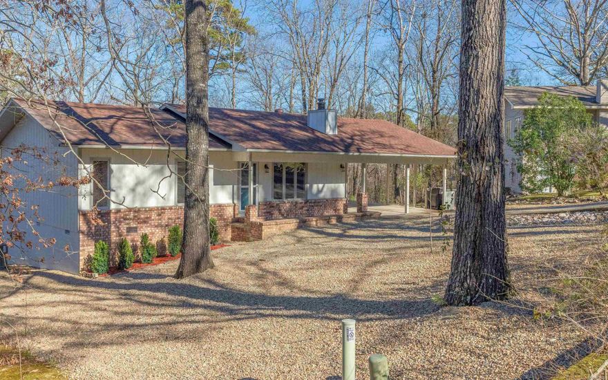 This gem is move in ready! Renovated from top to bottom all you have to do is unpack your bags. Smart floor plan gives you open rooms that take advantage of the natural light. Both bedrooms have on-suite baths with natural stone tile, and new fixtures with rain shower heads. The kitchen opens up to the living area and has granite countertops and backsplashes. Separate laundry/ mud room. Spacious sunroom for enjoying nature. Two car carport has added storage area. 2 workshop or storage areas as well in the rear of the house. Nice central location within the Village close to many amenities.  Hot Springs Village has a one time new owner buy in fee of $1500 that will be due at closing.