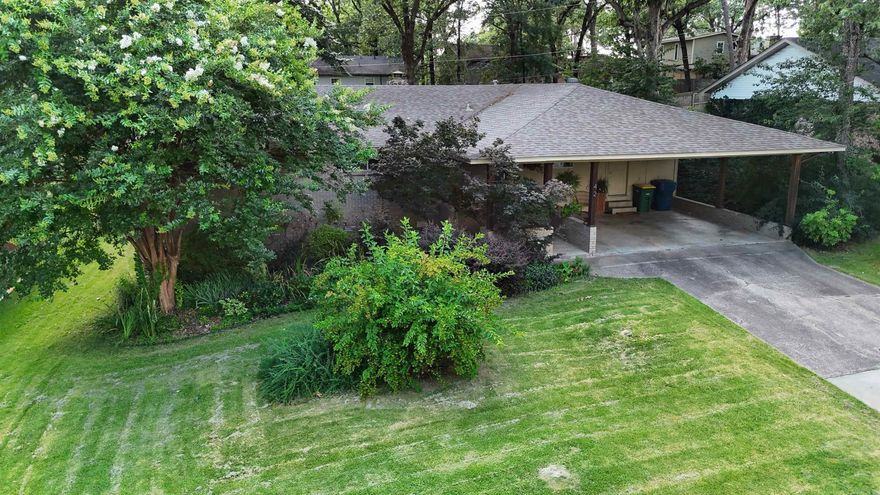 Move in ready with a spacious layout, the handsome brick exterior welcomes you through the two-car carport in the front, with wonderful natural beauty and landscaping. Come see this generous single-story floor plan ideal for families, with a versatile 4th bedroom that can serve as a home office, separate den, or bonus room. The huge living room features a double-sided, natural stone fireplace that gives you options for using the space many ways.  The eat in kitchen is well-equipped with dishwasher, disposal, range/oven. Washer and dryer hookups are conveniently tucked away in the kitchen. Throughout the home you will find abundant built-ins, ceiling fans, updated lighting, and window treatments. Outside, in the back yard, there is a heated and cooled shed/shop that can accommodate a playroom, or be a dedicated space for hobbies. The spacious concrete and stone patio overlooks the level, fully fenced backyard ideal for outdoor living, gardening or play. This home features major landscaping updates with beautiful native plants and trees, fully irrigated, and equipped with a dedicated compost bin to continue cultivating the space.