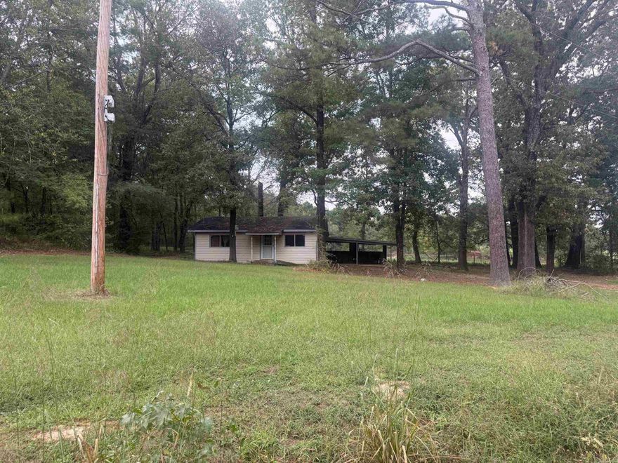 This is a fixer upper home; it currently has utilities on inside.  It is being sold "as is."  The 5.25 acres is cleared and wooded and would be a great place for livestock or a place to build another home. There are no restrictions on the property, and it is a great county setting not too far from town. Additional property available across the road.  Property is priced to sell, call today!