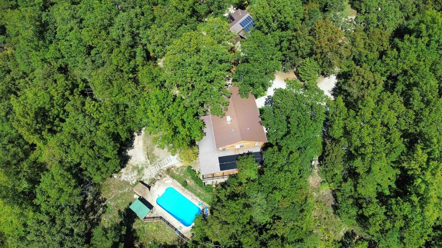 Experience the best of Ozark Mountain living on this stunning 200± acre property for sale in Calico Rock, Arkansas, just 5 miles from the world-famous White River.  Nestled in a small-town setting, this property offers rural country living with conveniences close by — including a small local airport, school, shopping and hospital for easy access. The land features rolling hills, hardwood timber, natural caves, abundant wildlife, and miles of trails for hiking, hunting, and exploring.  Three cabins are located on the property, perfect for Airbnb, VRBO, guest lodging, or family getaways. The main residence is spacious and comfortable, designed for both everyday living and entertaining, and boasts a unique underground swimming pool.  Whether you dream of a private family compound, a hunting retreat, or an income-producing rental property, this estate delivers. With its prime location near the White River, small-town charm, and endless recreational opportunities, this is a rare chance to own a large acreage tract in the Ozarks that truly has it all. Priced to sell for $1,190,000.