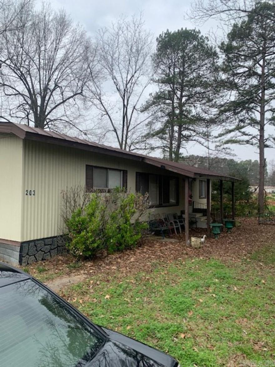 Investors welcome!! Livable double wide next to a new subdivision. Outbuilding and 3 covered parking spots. 3 beds, 2.5 baths. AS IS WHERE IS ALL FAULTS.
