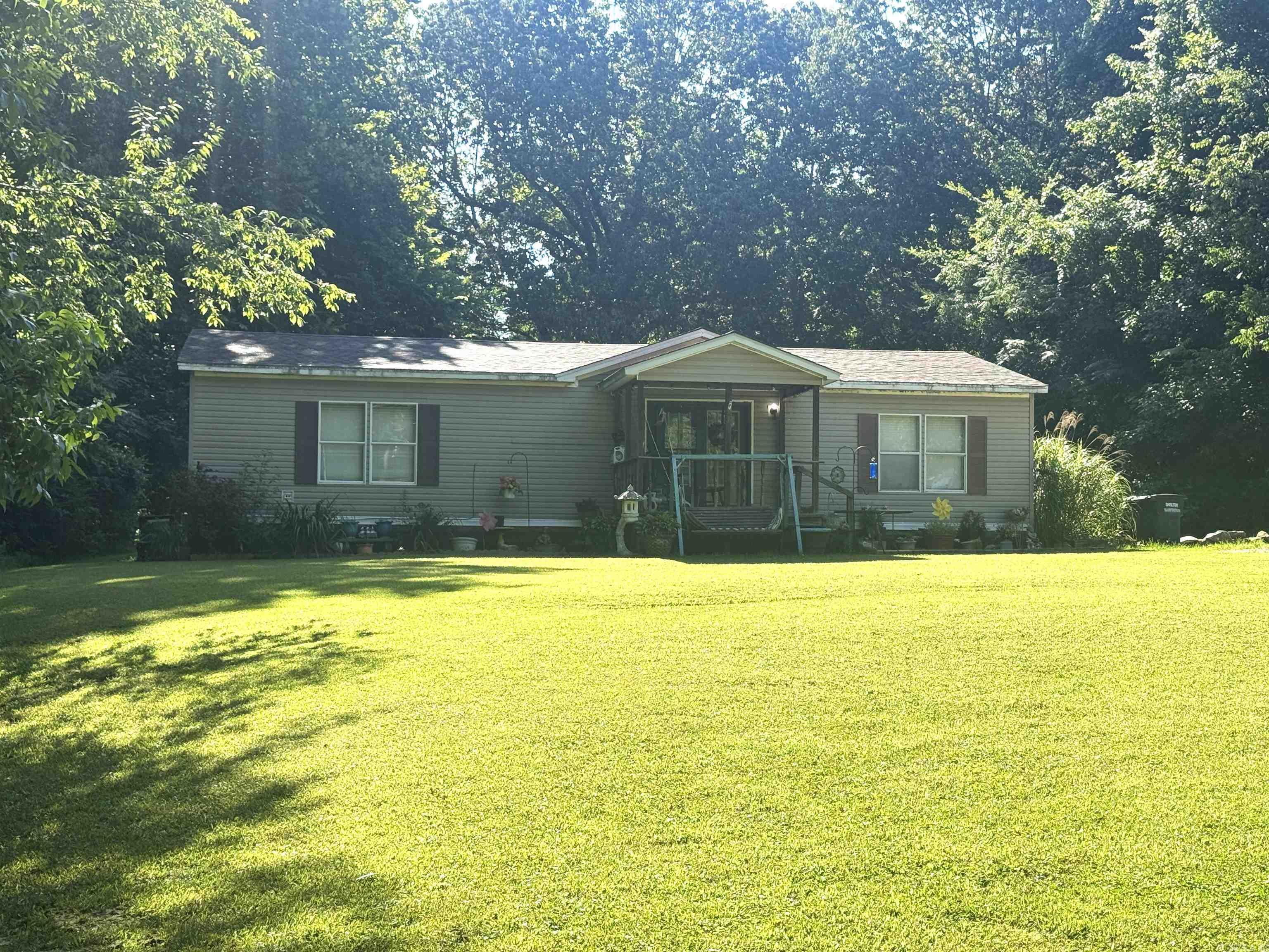 This 3-bedroom, 2-bathroom mobile home is situated on 0.71 acres, surrounded by trees for privacy. The backyard has endless possibilities. The house does need some TLC, such as painting the ceiling to address previous leaks before the new roof was installed in 2020. This home is full of potential! The property is sitting in a quiet neighborhood. Inside, you will find an all-electric home, along with a gas ventless heater for weather emergencies, a laundry room off the kitchen, and an open concept that extends from the dining room to the living room and kitchen.
