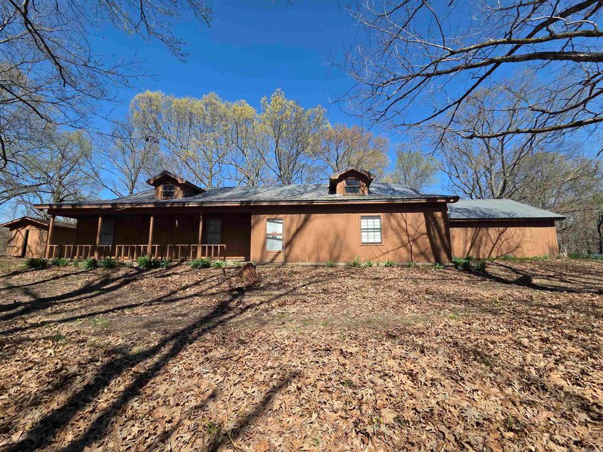 Tucked away on 2 private acres, this spacious one-owner home offers the perfect opportunity to create your dream country retreat. With 2,871 square feet, the home features 3 bedrooms, 2 bathrooms, and two separate living areas. The main living space features a large fireplace and wet bar. A newer metal roof offers durability and peace of mind for years to come. While the home needs updating and repairs, it presents an incredible opportunity to customize and add value in a peaceful, secluded setting. Surrounded by nature and set well off the road, the property offers privacy and tranquility. For those needing even more space, an additional 14.2 acres is available for purchase, opening up possibilities for recreation, a hobby farm, or future expansion. Conveniently located within an hour of Memphis and Jonesboro, this property combines the serenity of country living with easy access to city amenities. If you’re looking for privacy, space, and potential, this unique property is ready for you.