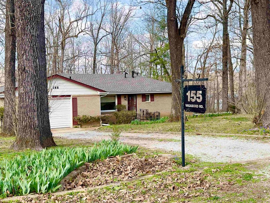 Nostalgic LAKE COMMUNITY of Ozark Acres complete with Lake Vagagond’s sandy beach and playground area is just minutes from Old Hardy Town and all the fun and relaxation that the Spring River Area has to offer! Whether you’re looking to embrace the retro atmosphere of this home or put your own spin and style into it, it is ready to be yours!  Upon entry there is a formal parlor room which of course could be an office or even made into another bedroom easily enough.  There are two good sized bedrooms with ample closet space and storage is everywhere!  In the private kitchen and den area, you'll see that it is open and inviting!  From the screened back porch you will overlook the wooded double lots and through the trees you can even see Lake Vagabond which is within a short  walking distance! There is plenty of storage both inside and out.  The garage houses an extra shower and powder room as well as the laundry and other work spaces for hobbies and such.  There is extra covered parking and sheds for boats, kayaks, or other fun things to keep! Priced to MOVE! MAKE YOUR MOVE TODAY!