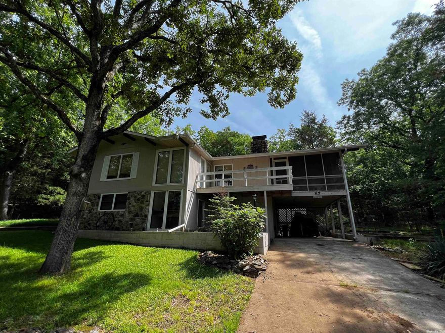 Nestled amongst the Ozark Mountains is this tree house like 2 bed 2.5 bath 1,900sqft 2 level home on 1 lot in Cherokee Village. No next door neighbors, surrounded by woods, and a mile from the North Golf Course and access to the  South Fork River. Walk into the foyer on the main level with the large family room and or could be the 3rd bedroom with a large wood burning fireplace and built in wardrobe closet. Walk back towards the foyer too the workshop which includes washer/dryer, and half bath. Venture up the stairs to the main living area with vaulted ceilings in the living room and kitchen. All appliances stay in the kitchen and notice the wood burning fireplace in the main living room. Upstairs also includes 2 bedrooms and 2 bathrooms. Off the living room enjoy the very large screened in porch with built in bars. Small storage shed out back. Home includes newer roof and newer heat and air unit.