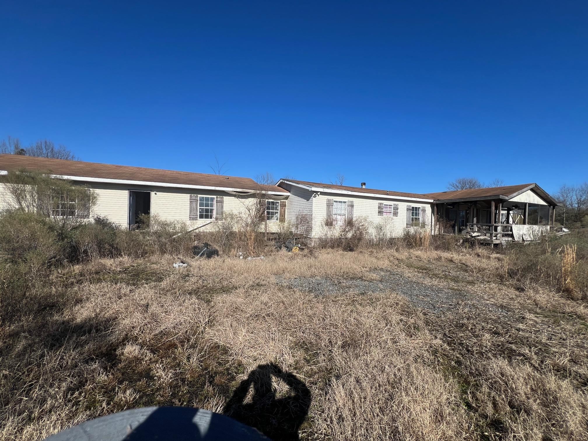 Large Doublewide mobile home with a separate joining structure for additional living space. 4.82 acres of land. Seller is negotiable make offer