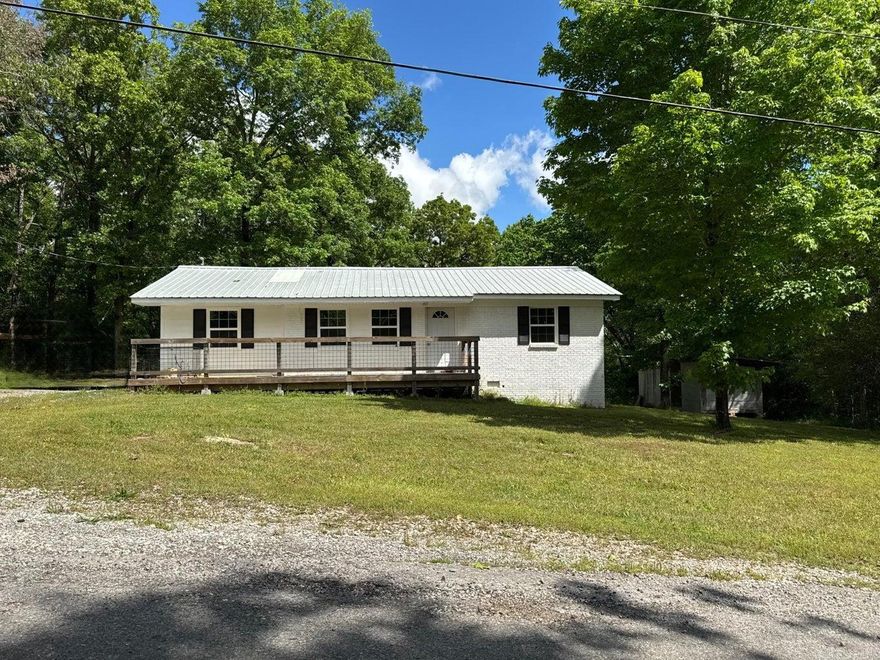 This beautifully updated 3-bedroom, 2-bath home on a 0.97 acre lot offers the perfect blend of in-town convenience and peaceful seclusion, with no visible neighbors for added privacy. Inside, you'll find durable and stylish wood-look tile flooring throughout, creating a cohesive and low-maintenance living space. Step outside to enjoy the inviting front deck--perfect for relaxing or entertaining--and a fenced area ideal for your furry friends. A convenient outdoor storage shed provides extra space for tools and equipment. This home truly combines comfort, style, and a rare sense of privacy right in town.