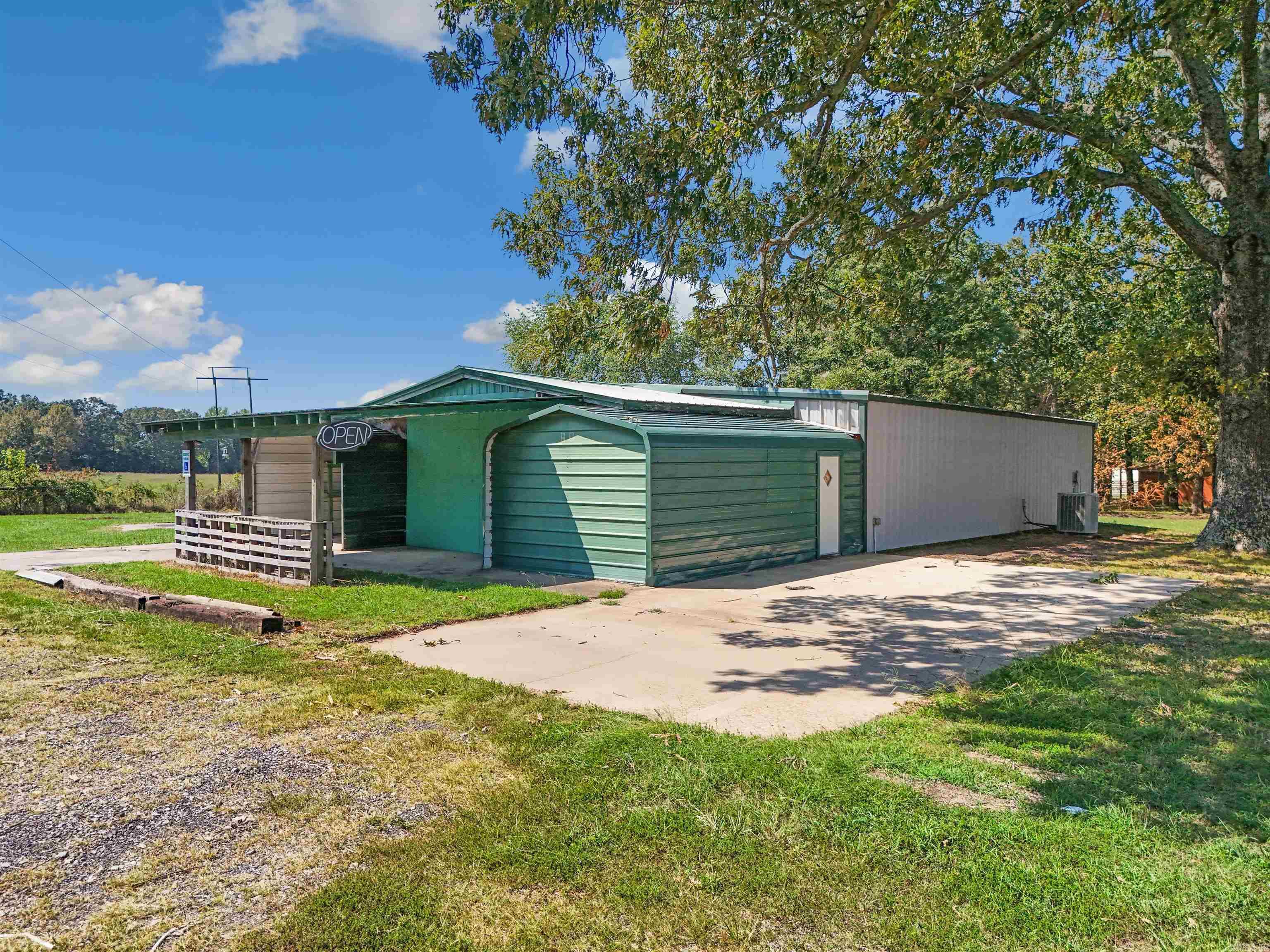 Opportunity awaits! Have you always wanted to open your own business? Maybe a farmstand, flea market, store, or office space? This 3365 sf building is heated and cooled, has a half bath, and a kitchenette, and is right across the highway from the thriving Arkansas Elite Welding Academy. HVAC has routine yearly maintenance. Building is 60' x 50' and has 10' ceilings. There's also a 18' x 40' pole shed. With over an acre space, there's so many possibilities. Be sure to check out the aerial drone video, and call today to schedule your showing.