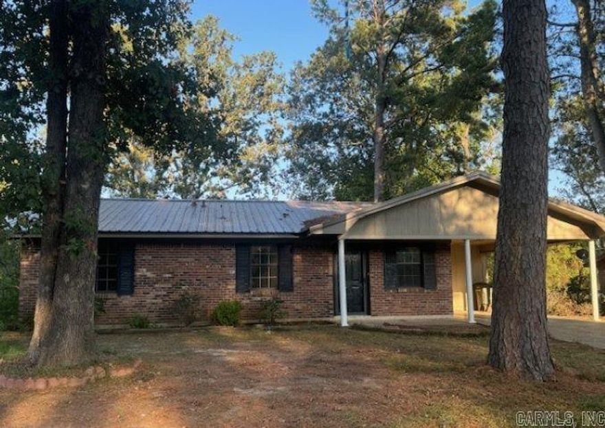 Perfect first home in Parkwood Addition.  3 bedrooms, 1.5 baths, 1324sf sits on .257ac lot.  Brick home with single covered carport. Open and light kitchen offers an electric stove, dishwasher, ample cabinet space, butcher block countertops and is open to the home's dining area and spacious living room.  Primary bedroom offers a convenient half bath, and 2 additional bedrooms share a full bath in the hall.  Vinyl flooring throughout for easy upkeep. You'll enjoy the covered patio and fenced yard in back providing space for the children and pets to play or just unwind after a long day.  City utilities service this area. Roof age is unknown but should be a long-lasting metal roof. Priced to sell and will be sold "as-is", "where-is".  Call today for your appointment to see this home.